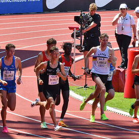 Mehrere Männer laufen in einer Reihe beim 1500-Meter-Lauf