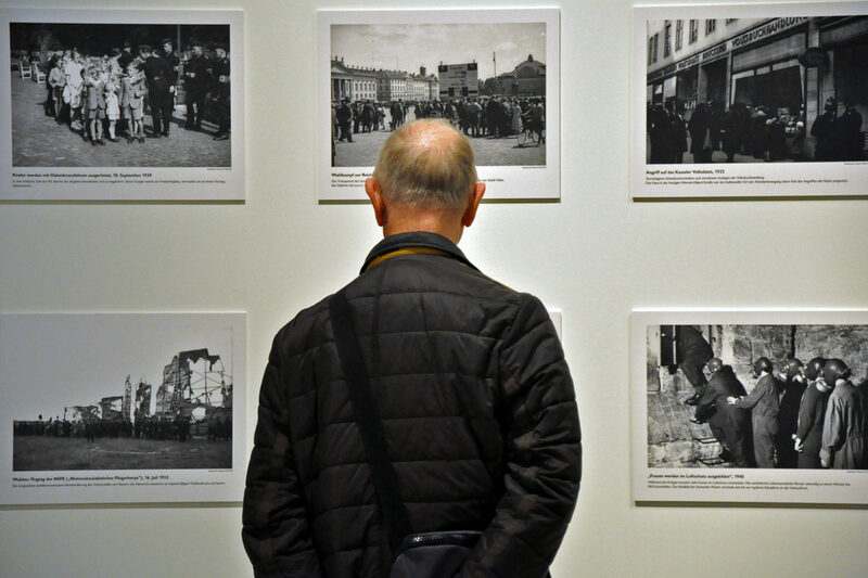Ein Mann schaut sich die Fotoausstellung Eberth an