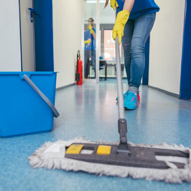 Close-up of cleaners moping the floor